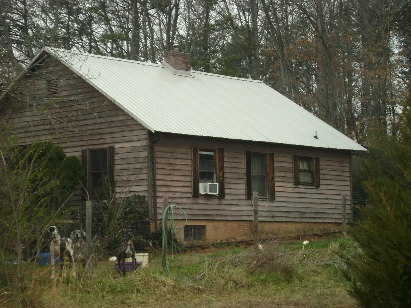 White metal roof on an old wood sided farmhouse, from a Metal Roof Installation job in Fishertown